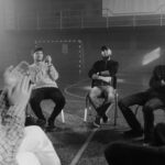 A black and white image of a support group engaged in a therapy session