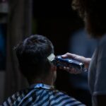 Barber using electric clipper for a precise haircut in a barber shop