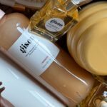 A stylish arrangement of Gisou hair products in a basket with natural aesthetics