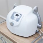 Close-up of a modern medical face massager on a sterile cabinet, essential for healthcare settings
