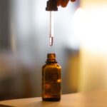 Close-up shot of a serum dropper above an amber bottle, with a soft blurred background and glowing light